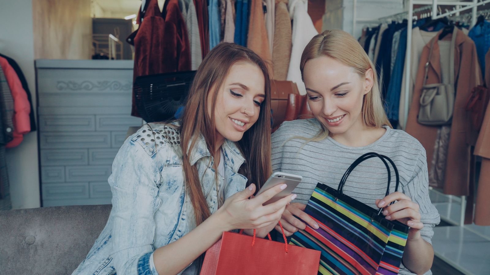Fashion shoppers sharing a mobile discovery moment